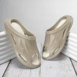 Red Tape beige EVA slides showing front angled view of pair with brand logo and ventilation holes for comfort