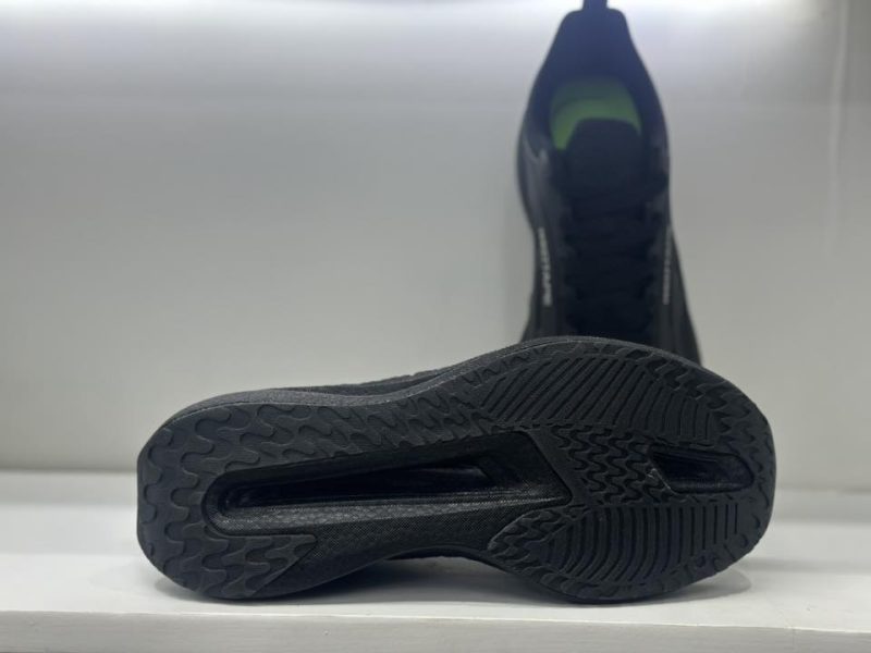 Close-up of the Red Tape black athleisure shoe sole, showing its aggressive grip pattern and durable rubber for enhanced traction.