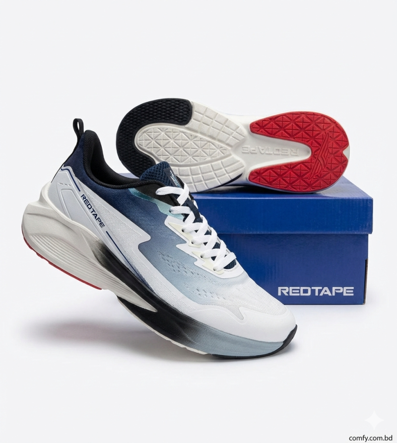 Angled view of white & navy RedTape men's lifestyle sports ked, showing durable red and black textured outsole & cushioned design.