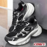 Two Red Tape women's chunky casual shoes, black and silver, with thick white soles, leaning against a wall.