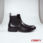 Side view of a men's black leather Chelsea boot on a white background, showing elastic panel and sturdy sole.