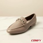 Angled top view of a stylish brown chain loafer for women on a white marble surface, featuring a unique silver chain detail.