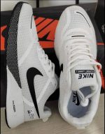 AeroFlex white running shoes pair, showcasing a side profile with black swoosh and a top-down view of the laces.