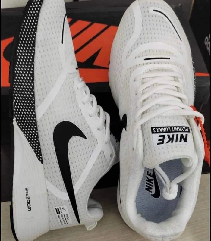 AeroFlex white running shoes pair, showcasing a side profile with black swoosh and a top-down view of the laces.