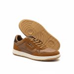 Side view of one Benetton men's brown lifestyle sneaker with the other shoe's patterned sole exposed behind it.