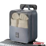 Grey TravelEase waterproof shoe bag attached to a silver suitcase handle, showcasing beige slippers through its mesh top, perfect for travel shoe storage.