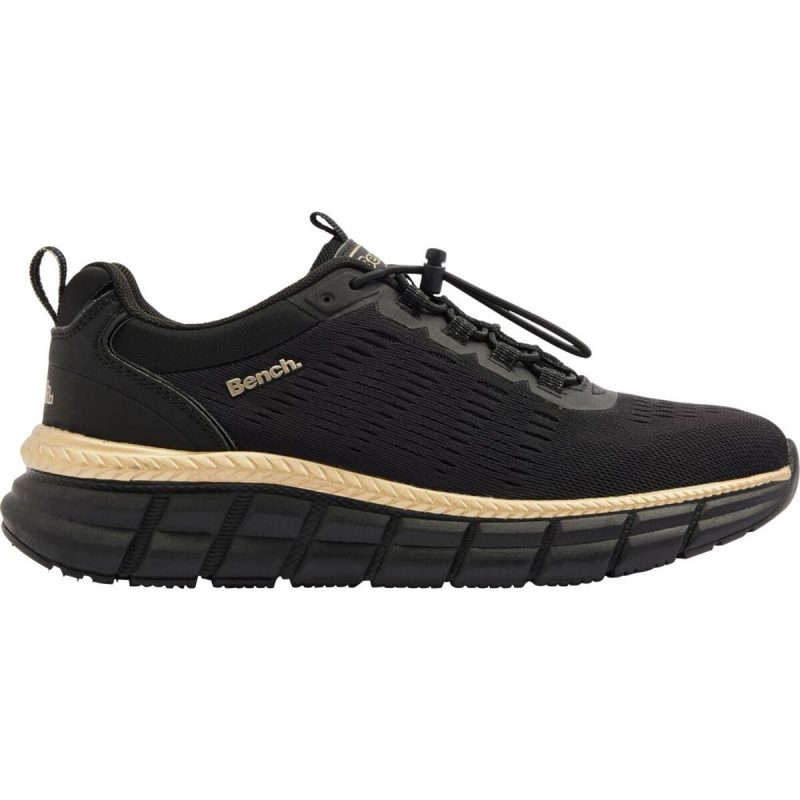 Lateral side profile of Bench black slip-on trainer with gold trim stripe and textured midsole.