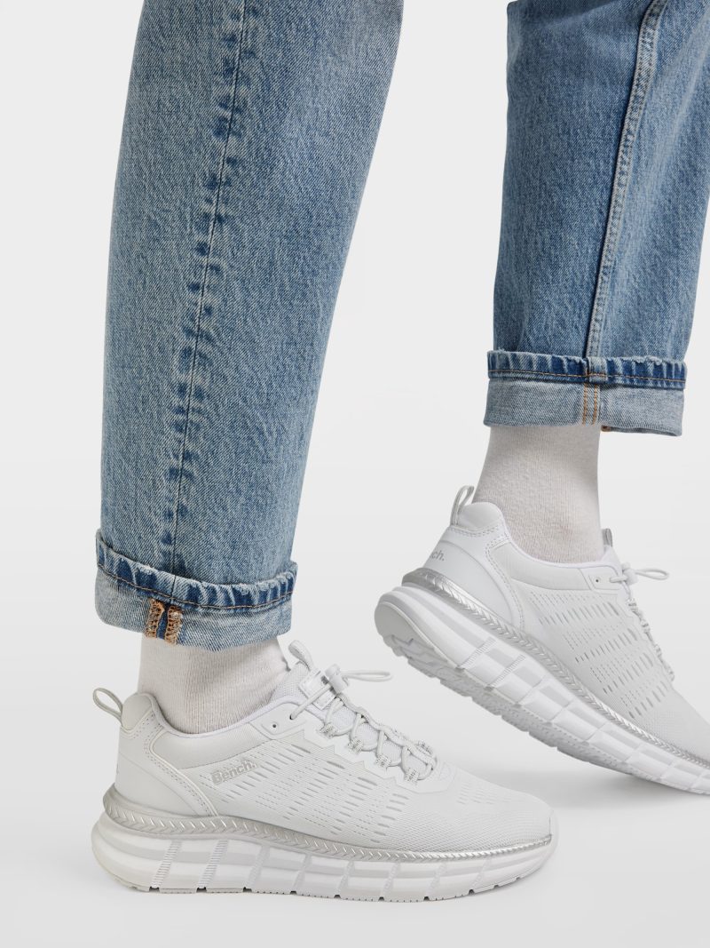 On-foot view of Bench White Slip-On Trainers styled with cuffed blue jeans.