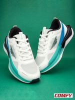 Red Tape AirFlex Pro running shoes in white and aqua blue on a green background.
