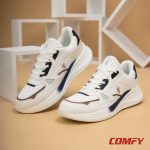 Detailed angle shot of Red Tape sneakers on tan background