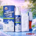 Complete Biki Shoes Foam Cleaner kit including spray bottle, brush, towel, and box on a splashy background.