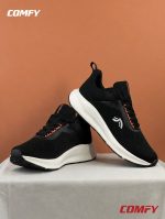 Angled view of CRIVIT black women's running shoes highlighting the ergonomic design.
