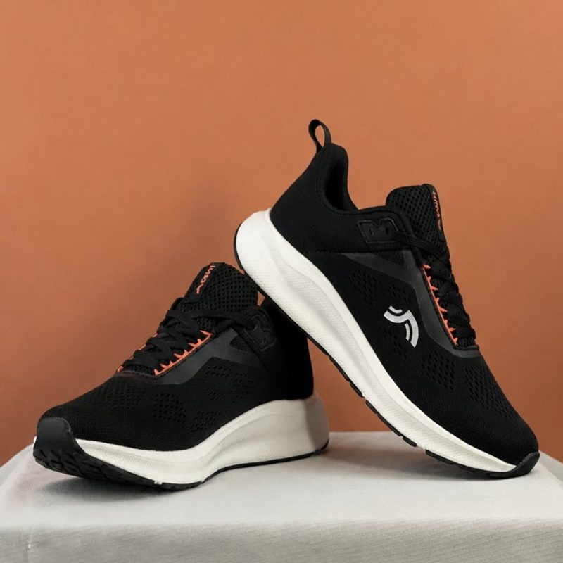 Angled view of CRIVIT black women's running shoes highlighting the ergonomic design.
