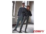 Couple modeling streetwear with the man in green pants and navy leisure sneakers.