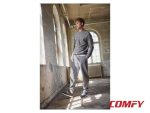 Man wearing a grey lounge tracksuit paired with navy blue casual sports shoes.