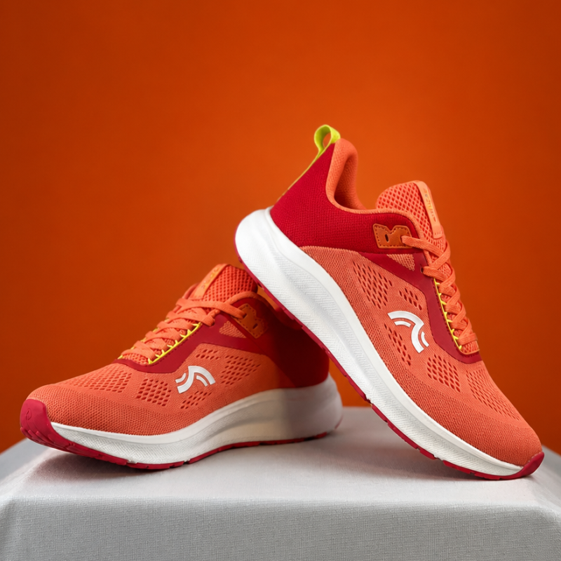 Pair of CRIVIT bright orange and pink women's running trainers.