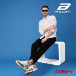 Man wearing Bond Street white beige sneakers, white button shirt, black pants.