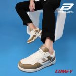 Model wearing white and brown Bond Street sneakers with black trousers.
