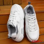 White Red Tape lifestyle sneakers sitting on rustic wooden stairs.